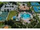 Resort-style pool and tennis courts from above at 11584 Dancing River Dr, Venice, FL 34292