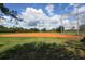 Baseball field with backstop and seating at 11584 Dancing River Dr, Venice, FL 34292