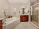 Spa-like bathroom with soaking tub, walk-in shower, and dual sinks at 11584 Dancing River Dr, Venice, FL 34292