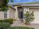 Front entry with teal door and brick walkway at 11584 Dancing River Dr, Venice, FL 34292