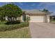 Single-story home with a two-car garage and landscaped front yard at 11584 Dancing River Dr, Venice, FL 34292