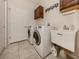 Bright laundry room with washer, dryer, and utility sink at 11584 Dancing River Dr, Venice, FL 34292