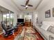 Spacious living room with hardwood floors, fireplace, and access to lanai at 11584 Dancing River Dr, Venice, FL 34292