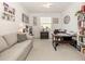 Home office with built-in shelving, desk, and comfortable seating at 11584 Dancing River Dr, Venice, FL 34292