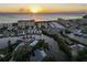 Sunrise aerial view of waterfront condominiums and boat docks at 1200 Tarpon Center Dr # 108, Venice, FL 34285