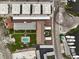 Aerial view of condo community featuring a swimming pool, boat parking, and well-maintained landscaping at 1200 Tarpon Center Dr # 108, Venice, FL 34285