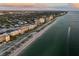Coastal aerial view with beachfront condos and boat marina at 1200 Tarpon Center Dr # 108, Venice, FL 34285
