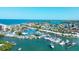 Aerial view of a coastal community with beautiful marina featuring numerous boats docked along the waterfront at 1200 Tarpon Center Dr # 108, Venice, FL 34285