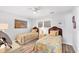 Charming bedroom featuring two twin beds with colorful floral bedspreads, and wood-look floors at 1200 Tarpon Center Dr # 108, Venice, FL 34285