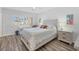 Bright main bedroom with wood floors and a large window, offering lots of natural light at 1200 Tarpon Center Dr # 108, Venice, FL 34285