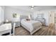This bedroom features a bed with decorative pillows, a ceiling fan, and a dresser with a mirror at 1200 Tarpon Center Dr # 108, Venice, FL 34285