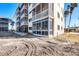 Condominium building showcasing multiple balconies and an enclosed sunroom at 1200 Tarpon Center Dr # 108, Venice, FL 34285