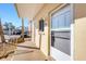Ground floor entrance with exterior lights and palm trees at 1200 Tarpon Center Dr # 108, Venice, FL 34285