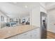 Open kitchen with stainless steel appliances and views of the open-plan living area at 1200 Tarpon Center Dr # 108, Venice, FL 34285