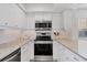 Bright kitchen with stainless steel appliances and modern finishes at 1200 Tarpon Center Dr # 108, Venice, FL 34285