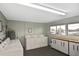 Large laundry room featuring multiple washers and dryers and ample cabinet space at 1200 Tarpon Center Dr # 108, Venice, FL 34285