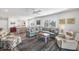 Open-concept living room with a cozy seating area and adjacent dining space at 1200 Tarpon Center Dr # 108, Venice, FL 34285