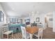 Light-filled open-plan living and dining area featuring wood floors and views of the beach at 1200 Tarpon Center Dr # 108, Venice, FL 34285
