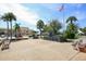 Outdoor plaza featuring benches, monument, and lush palm trees, perfect for community gatherings and relaxation at 1200 Tarpon Center Dr # 108, Venice, FL 34285