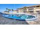 Resort-style pool with sunny deck, palm trees, and gulf views for relaxed coastal living at 1200 Tarpon Center Dr # 108, Venice, FL 34285