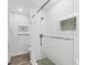 Bathroom showcasing a glass enclosed shower with subway tile and river rock floor at 1200 Tarpon Center Dr # 108, Venice, FL 34285