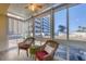 Bright sunroom with tiled floor, wicker furniture, and views of the beach at 1200 Tarpon Center Dr # 108, Venice, FL 34285
