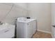 Laundry room with washer, dryer, utility sink and shelving at 12000 Blazing Star Dr, Venice, FL 34293