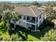 Luxury condo with tile roof, balcony, and lush landscaping at 121 Preserve Pl # A, Nokomis, FL 34275