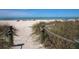 Sandy beach access with rope walkway leading to shore at 121 Preserve Pl # A, Nokomis, FL 34275