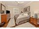 Comfortable main bedroom featuring dark wood floors and a ceiling fan at 121 Preserve Pl # A, Nokomis, FL 34275