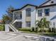 Two-story condo building with a staircase and landscaping at 121 Preserve Pl # A, Nokomis, FL 34275