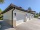 Three-car garage with white doors and tan-colored walls at 121 Preserve Pl # A, Nokomis, FL 34275