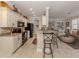 Well-equipped kitchen featuring granite counters, stylish cabinetry, and breakfast bar at 121 Preserve Pl # A, Nokomis, FL 34275