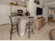 Kitchen with granite countertops, white cabinets, and black appliances at 121 Preserve Pl # A, Nokomis, FL 34275