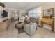 Bright living room with comfy seating, built-in shelving, and tiled floors at 121 Preserve Pl # A, Nokomis, FL 34275
