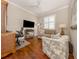 Home office featuring wood floors, a comfortable couch, and built-in desk at 121 Preserve Pl # A, Nokomis, FL 34275