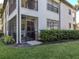 Screened-in porch with seating area and lush landscaping at 121 Preserve Pl # A, Nokomis, FL 34275