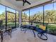 Relaxing screened porch with outdoor seating and lush landscaping views at 121 Preserve Pl # A, Nokomis, FL 34275