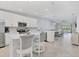 Modern kitchen with white cabinets and island at 12440 Wellen Golf St # 208, Venice, FL 34293