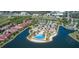 Aerial view of community with pool, tennis courts and lake at 125 Soliera St, Nokomis, FL 34275