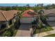 Aerial view of single-Gathering house with tile roof, landscaping, and driveway at 125 Soliera St, Nokomis, FL 34275
