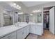 Double vanity bathroom with white cabinets, quartz countertop, and a large mirror at 125 Soliera St, Nokomis, FL 34275