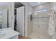 Clean bathroom with a walk-in shower, neutral tile, and a built-in bench at 125 Soliera St, Nokomis, FL 34275