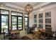 Community room with tables, chairs, and large windows at 125 Soliera St, Nokomis, FL 34275