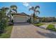 Single-Gathering home exterior with brick driveway and palm trees at 125 Soliera St, Nokomis, FL 34275