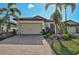 Single-Gathering home exterior with light beige walls and a tile roof at 125 Soliera St, Nokomis, FL 34275