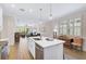 Open concept kitchen with island and view into adjacent living space at 125 Soliera St, Nokomis, FL 34275
