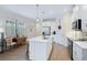 Bright kitchen featuring white cabinetry, an island, and a breakfast nook at 125 Soliera St, Nokomis, FL 34275
