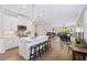 Open kitchen with white cabinets, island, and stainless steel appliances at 125 Soliera St, Nokomis, FL 34275