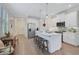 White kitchen with large island, stainless steel appliances, and open floor plan at 125 Soliera St, Nokomis, FL 34275